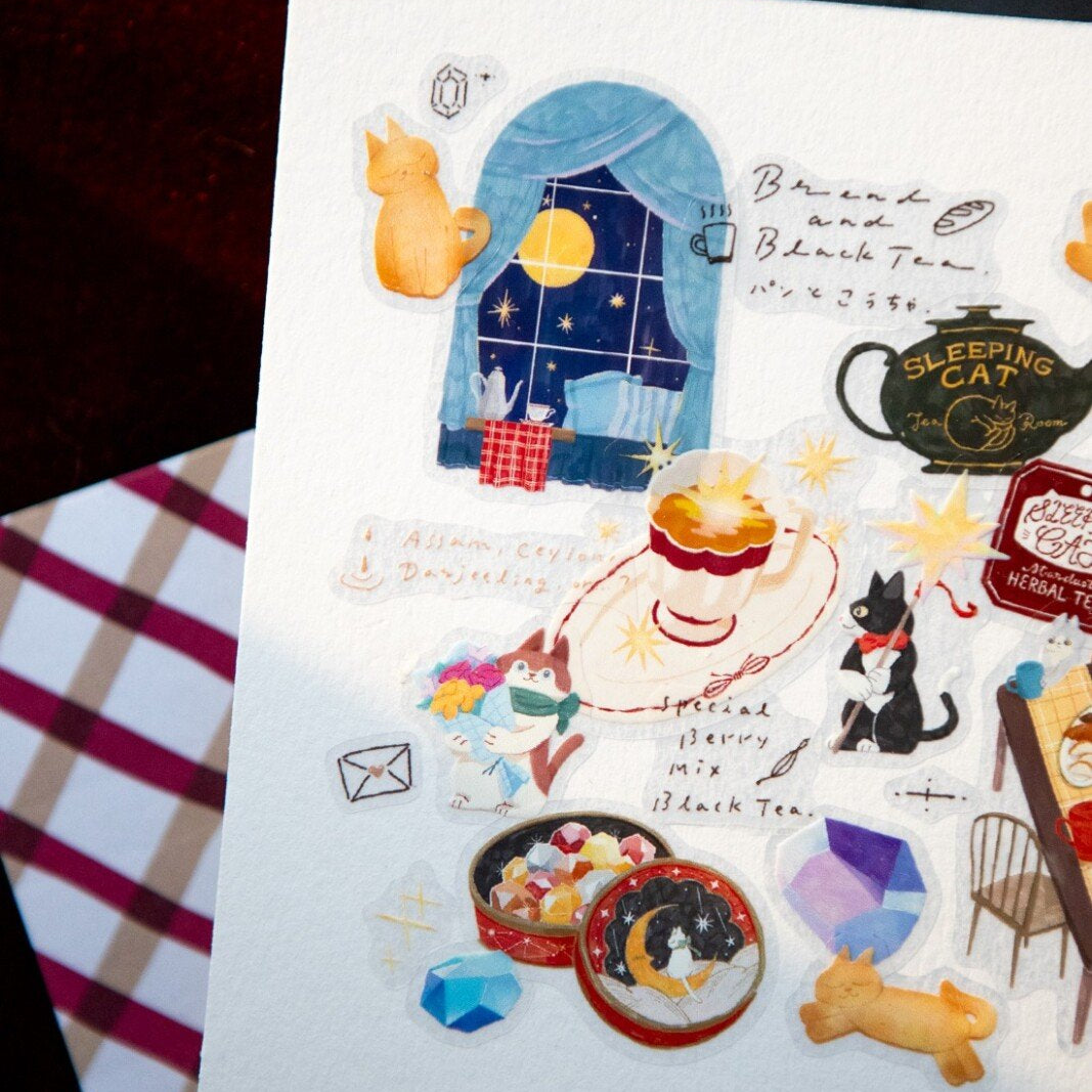 Welcome to the Tea Room! This kiss-cut PET Tape features a relaxing teahouse filled with cats and other furry friends. It adds the perfect touch of warmth to your journal pages with hints of golden brown and dark blue as conversations continue until midnight.