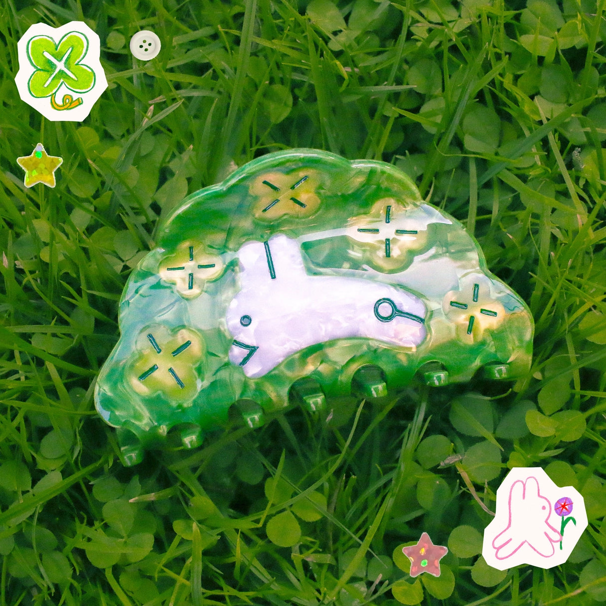 Clover Hair Claw featuring a little rabbit leaping through a field of clover.
Made of acetate, 3.5 inches long. 