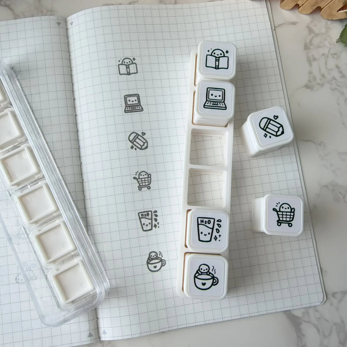 6-in-1 removable stamps for Daily Essentials.
Can be used right in the bracket or taken out for more precise stamping. The stamps are self-inking and come in a transparent case!
***IMPORTANT: Stamps come very well inked. Make sure you use scrap paper to stamp off excess ink prior to using in your notebooks
STAMP SET SIZE: 10.75cm (L) x 2.5cm (W) x 2.75cm (H)
INDIVIDUAL STAMP SIZE: 1.5cm x 1.5cm
INK COLOUR: Black (refillable)