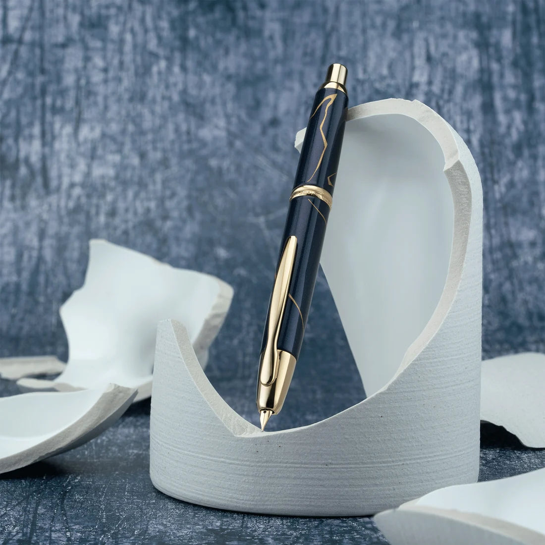 Pilot Vanishing Point Fountain Pen - Golden Journey - 2026 Limited Edition
Inspired by the Japanese art and philosophy of Kintsugi, Golden Journey honors the beauty found in transformation, resilience, and continuity. In Kintsugi, broken pottery is repaired with gold, allowing each line to become part of the object’s story rather than something to conceal. The 2026 Limited Edition brings this philosophy to life through a luminous pearlescent dark blue barrel accented with lines of metallic gold paint, crea