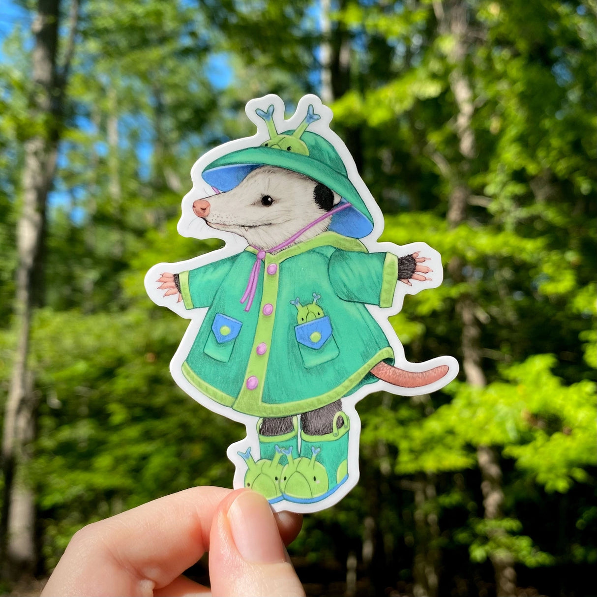 This weatherproof vinyl sticker features my illustration of a opossum dressed up in caterpillar rain gear.
This die-cut gloss 4” vinyl sticker is durable, weatherproof, and perfect for water bottles, notebooks, laptops, bikes, and all sorts of other surfaces! Make sure to clean and dry the surface thoroughly before applying.