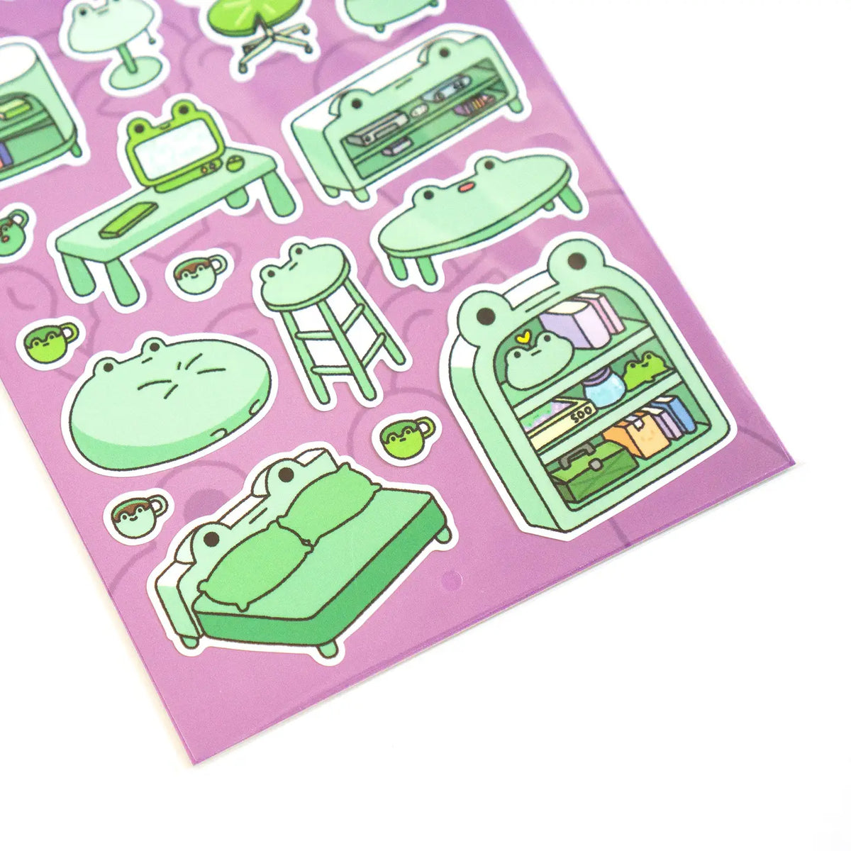 This is part of a new series of sticker sheets that feature different "days".
There are 20 individual stickers on the sheet full of frog furniture.
They are vinyl stickers on a clear plastic sheet with a backing card.
The whole packaging is 3.8 x 8.75" and is ready to hang.
The sticker sheet is 3.75 x 5.8"