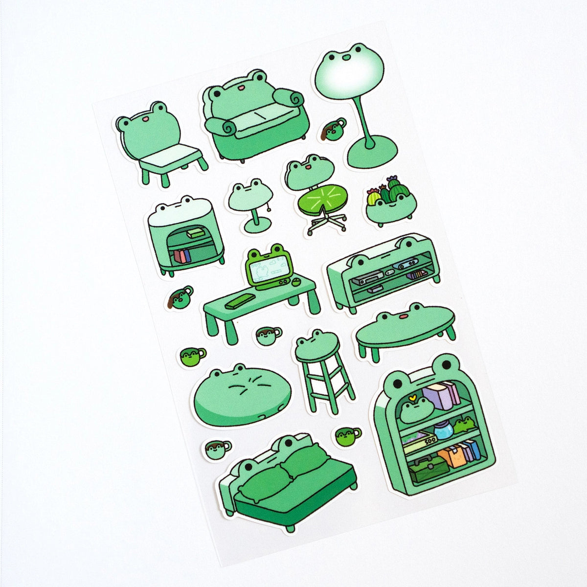This is part of a new series of sticker sheets that feature different "days".
There are 20 individual stickers on the sheet full of frog furniture.
They are vinyl stickers on a clear plastic sheet with a backing card.
The whole packaging is 3.8 x 8.75" and is ready to hang.
The sticker sheet is 3.75 x 5.8"
