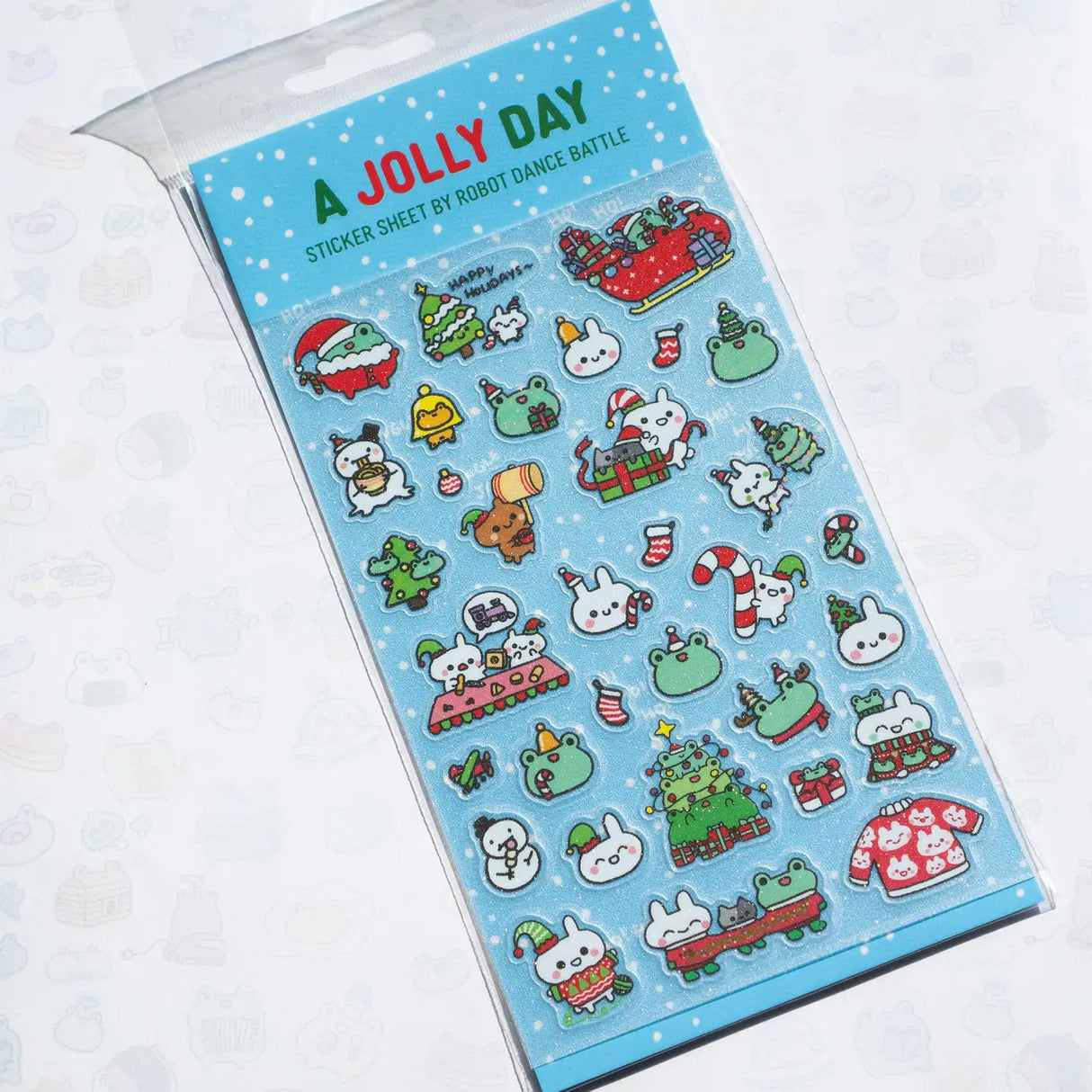 This is part of a new series of sticker sheets that feature different "days".
There are 33 individual glitter stickers on the sheet full of holiday joy!
They are plastic stickers on a frosted plastic sheet with a backing card and packaging that's ready to display.