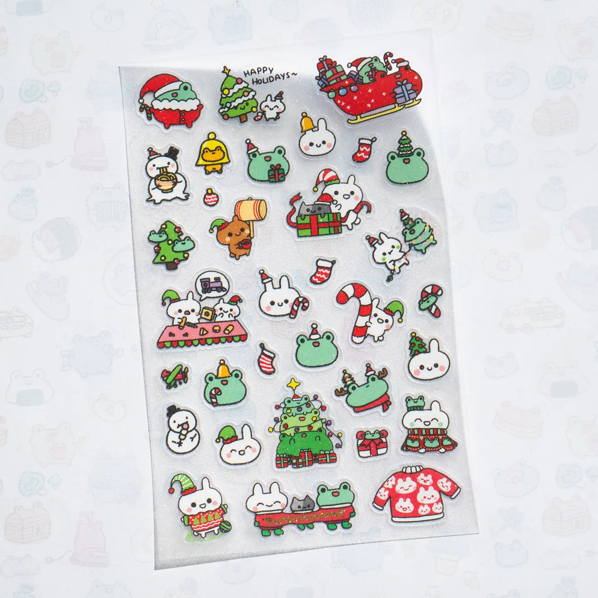 This is part of a new series of sticker sheets that feature different "days".
There are 33 individual glitter stickers on the sheet full of holiday joy!
They are plastic stickers on a frosted plastic sheet with a backing card and packaging that's ready to display.