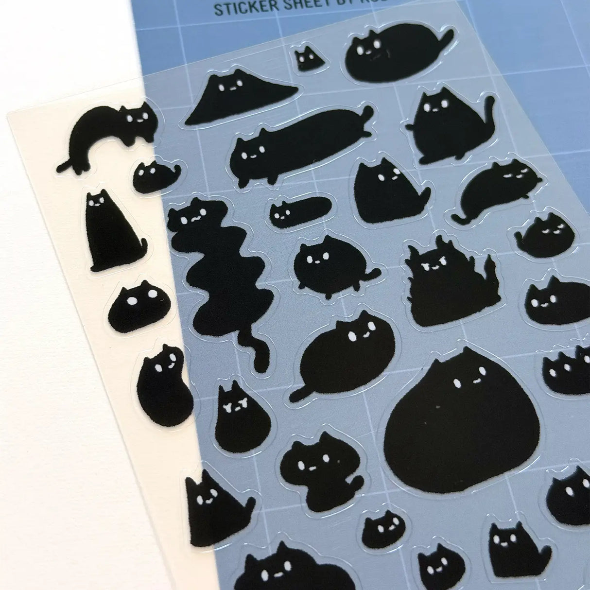 This is part of a new series of sticker sheets that feature different "days".
This one features Sumi the cat on an odd day.
There are 39 individual stickers on the sheet.
They are plastic stickers on a plastic sheet with a backing card and packaging that's ready to display.
The whole packaging is 3.8 x 8.75" and is ready to hang.
The sticker sheet is 3.75 x 5.8"