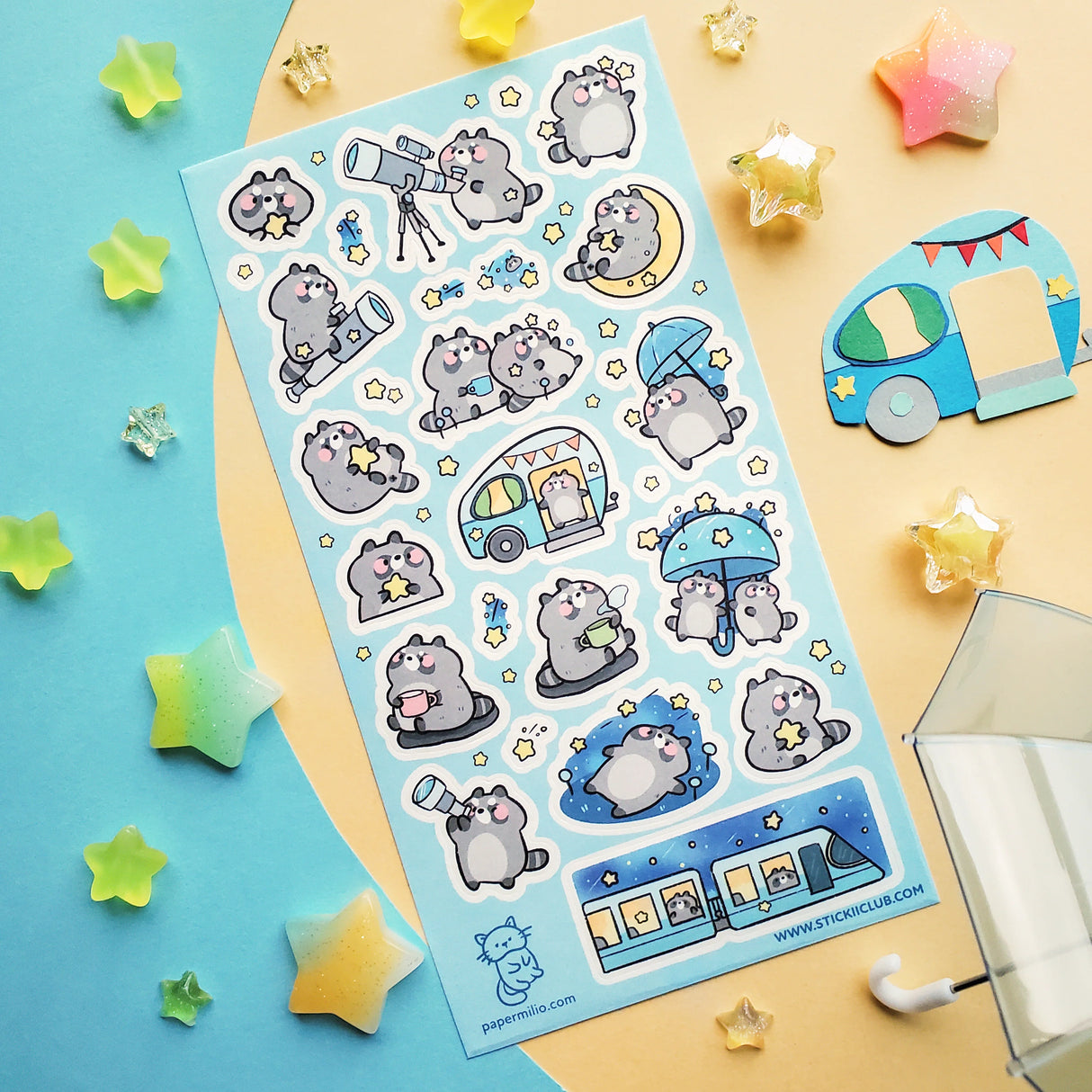 🌟🦝 Adventure calls, and these chonky little stargazers by @papermilio are answering, with snacks packed and eyes on the sky! From peeking through telescopes and wishing on shooting stars to camper trips, and umbrella strolls beneath twinkly skies, these cosmic cuties are following the stars—wherever they may lead.
