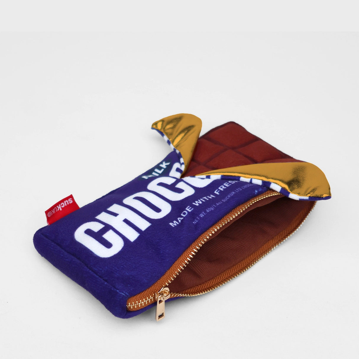 Plush chocolate bar shaped case with gold zip. Store your belongings in style by tucking them into this sweet treat. Yum!
Juicy, tasty, sweet and sour. And very cute. Stuff your stuff into something soft, and squishy. Delicious looking plush zip pouches look like foodie treats but instead of calories, they hold your everyday essentials. From cheesy slices to sickly treats, each pouch is designed to be irresistible and practical. Perfect for pens, cables, cosmetics, or whatever bits and bobs you need to sta