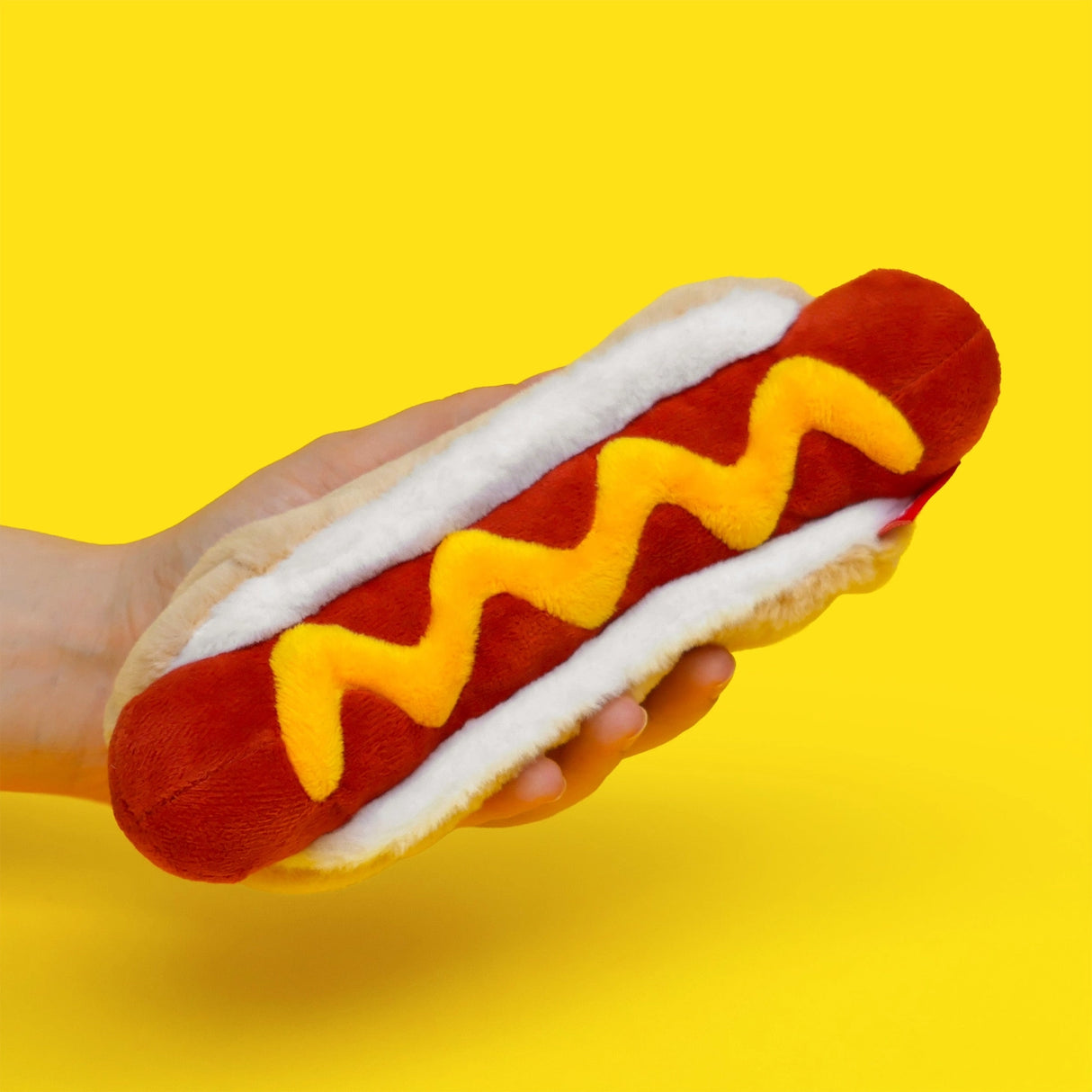 Store stationery or other small items
Plush hot dog shaped case with gold zip. Store your belongings in style by filling your hot dog bun full. Yum!
Plush Zip Pouches designed and made by SuckUK
Juicy, tasty, sweet and sour. And very cute. Stuff your stuff into something soft, and squishy. Delicious looking plush zip pouches look like foodie treats but instead of calories, they hold your everyday essentials. From cheesy slices to sickly treats, each pouch is designed to be irresistible and practical. Perf