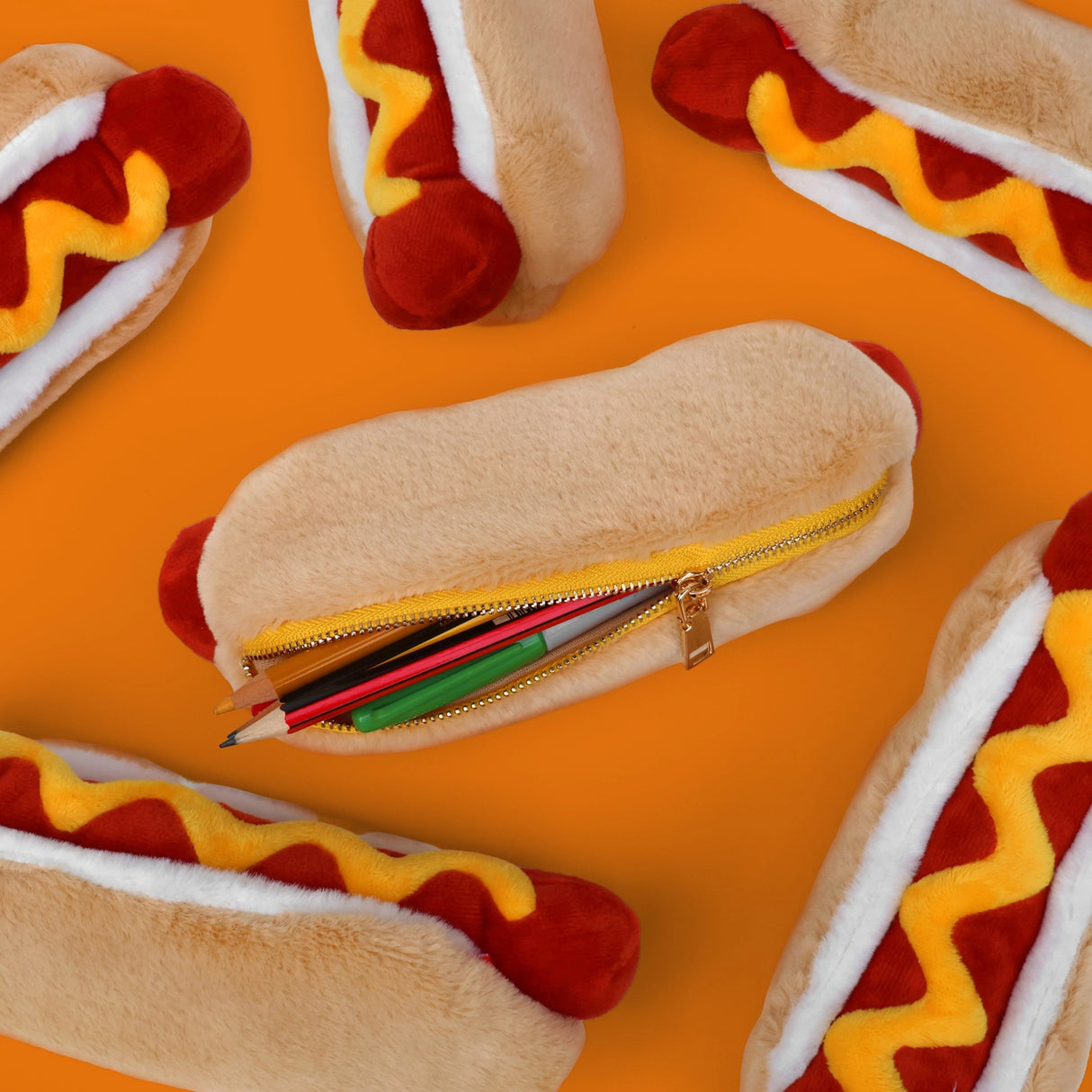 Store stationery or other small items
Plush hot dog shaped case with gold zip. Store your belongings in style by filling your hot dog bun full. Yum!
Plush Zip Pouches designed and made by SuckUK
Juicy, tasty, sweet and sour. And very cute. Stuff your stuff into something soft, and squishy. Delicious looking plush zip pouches look like foodie treats but instead of calories, they hold your everyday essentials. From cheesy slices to sickly treats, each pouch is designed to be irresistible and practical. Perf