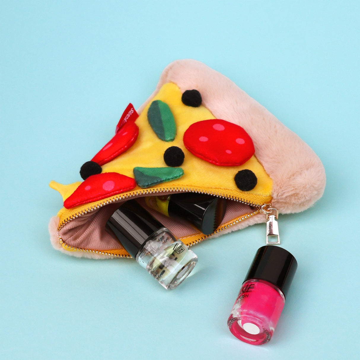 Store stationery & small items.
Plush pizza shaped case with gold zip. Store your belongings in style by tucking them into this slice of delicious pizza. Yum!
Plush Zip Pouches designed and made by SuckUK
Juicy, tasty, sweet and sour. And very cute. Stuff your stuff into something soft, and squishy. Delicious looking plush zip pouches look like foodie treats but instead of calories, they hold your everyday essentials. From cheesy slices to sickly treats, each pouch is designed to be irresistible and practi