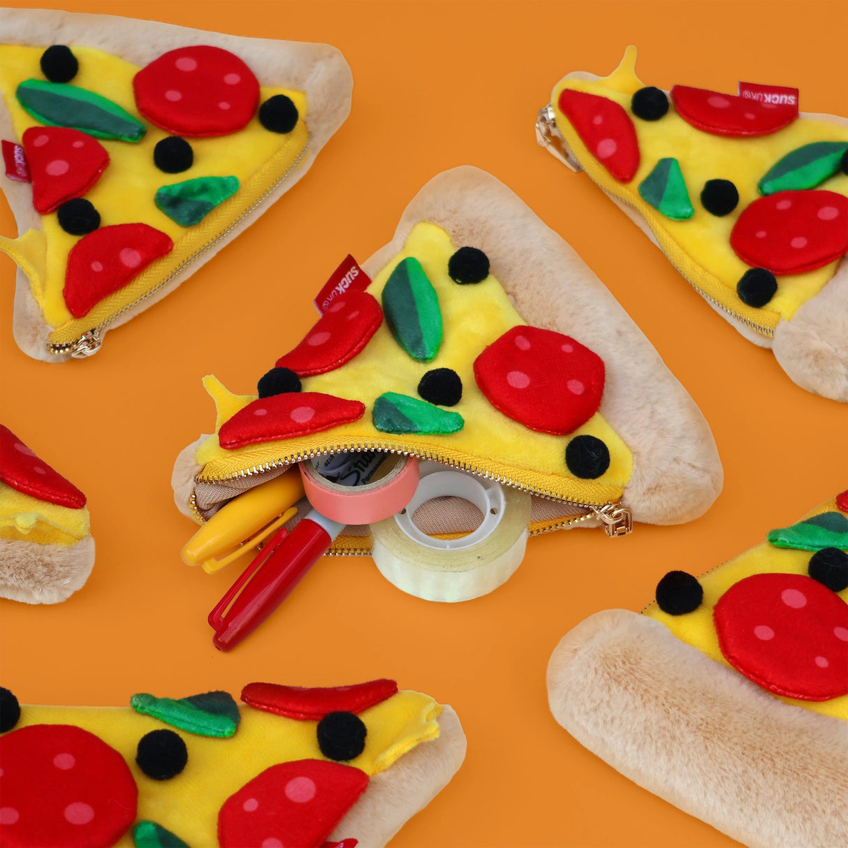 Store stationery & small items.
Plush pizza shaped case with gold zip. Store your belongings in style by tucking them into this slice of delicious pizza. Yum!
Plush Zip Pouches designed and made by SuckUK
Juicy, tasty, sweet and sour. And very cute. Stuff your stuff into something soft, and squishy. Delicious looking plush zip pouches look like foodie treats but instead of calories, they hold your everyday essentials. From cheesy slices to sickly treats, each pouch is designed to be irresistible and practi