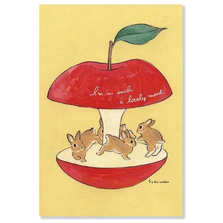 Join the fun with this postcard by Schinako Moriyama! This postcard features bunnies circling in an apple with the message "I'm in such a lovely mood".
4in x 5.8in