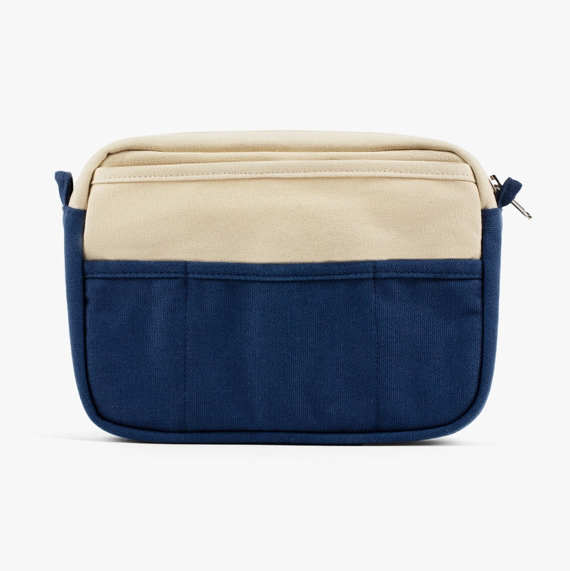 A compact carry-all pouch for artists, makers, and stationary lovers who appreciate a little order in their chaos. Structured enough to hold its form, soft enough to fit anywhere, and fully machine-washable for the days that get a little messy — your tools, pens, and creative essentials stay safe, visible, and ready wherever you go.
Inside, 20 pockets make space for art supplies, stationary essentials, and an A5 notebook, all secured by a smooth YKK zipper. Sized to fit within larger bags or carry on its o