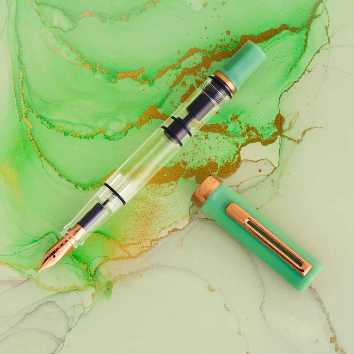 TWSBI ECO Jade Jelly w/ Bronze Fountain Pen
The Jade Jelly TWSBI eco features a lovely milky looking green that nicely matches its name. The jade coloring is offset with polished bronze trim and nib. Its piston-filling system and smooth steel nib deliver a consistent, enjoyable writing experience for journaling, note‑taking, and everyday use.
Featuring a cream-and-clear resin body with bronze trim, this pen’s transparent barrel lets you monitor ink levels while showcasing TWSBI’s precision piston mechanis