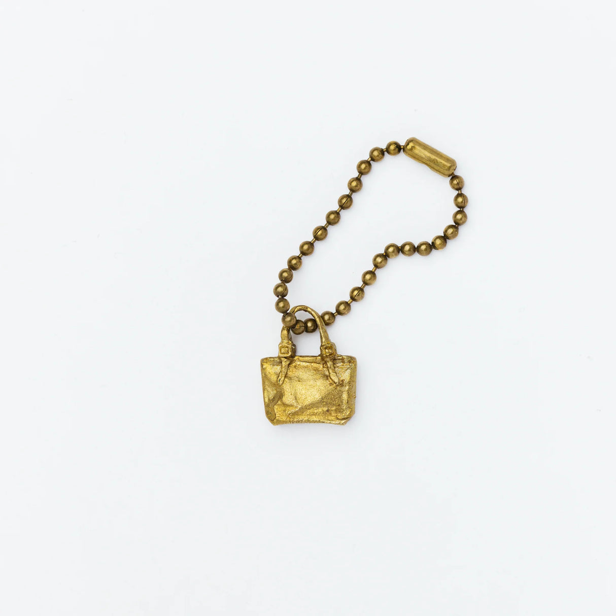 Brass charm in the shape of an engineer tote bag.
Equipped with a sleek ball chain, it attaches effortlessly to your bags, pouches, or key rings. Despite its petite size, it brings the distinct, rich texture and unmistakable presence that only genuine brass can provide.
As you use it, the brass will develop a natural patina over time—enjoy the changing character that comes with age.
Color: The color you see on your screen may differ from the actual product.
Brass Products
Due to the nature of brass, so