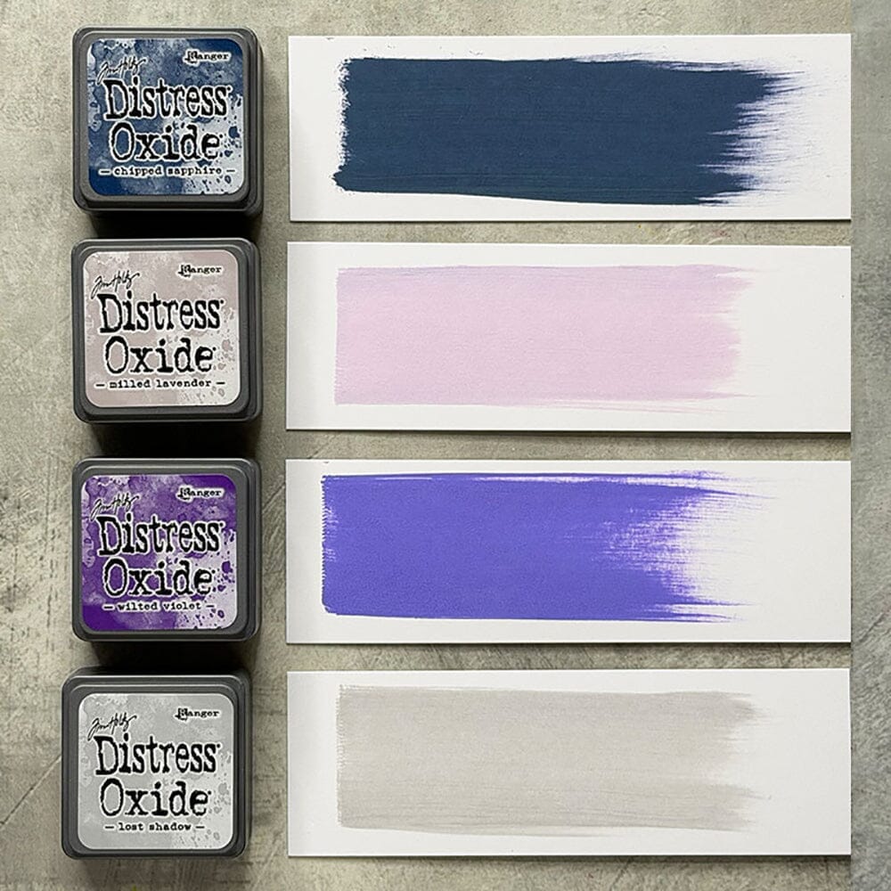 Tim Holtz Distress Mini Oxide Ink Pads are a collection of 1 x 1 cubes featuring water-reactive dye & pigment ink fusion that creates an oxidized effect when sprayed with water.