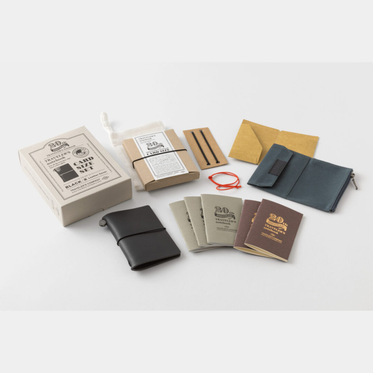 To commemorate this 20th anniversary, we’ve created a new size of TRAVELER’S notebook.
It is TRAVELER’S notebook Card Size. This TRAVELER’S notebook is always with you, even in your daily life. Whether it’s a sudden idea, information you learned or overheard, or something important you don’t want to forget— whenever and wherever you feel like writing, you can quickly grab the notebook and jot it down.
This set includes TRAVELER’S notebook Card Size, Refill Notebooks, Cotton Zipper Case, Kraft Paper Folder