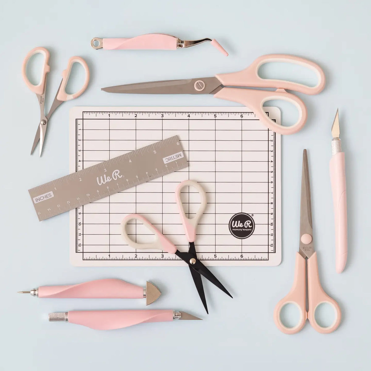 The We R Makers Mini Tool Kit in Pink is the ultimate companion for all your DIY craft projects. This comprehensive kit includes essential tools: a cutting mat, ruler, scissors, craft knife, tweezers, brad setter, and piercing tool. Designed for versatility, it's perfect for scrapbooking, journaling, card making, and a wide range of other crafts.
The vibrant pink color adds a fun and stylish touch to your toolkit, while the high-quality construction ensures each tool is durable and reliable. The cutting ma
