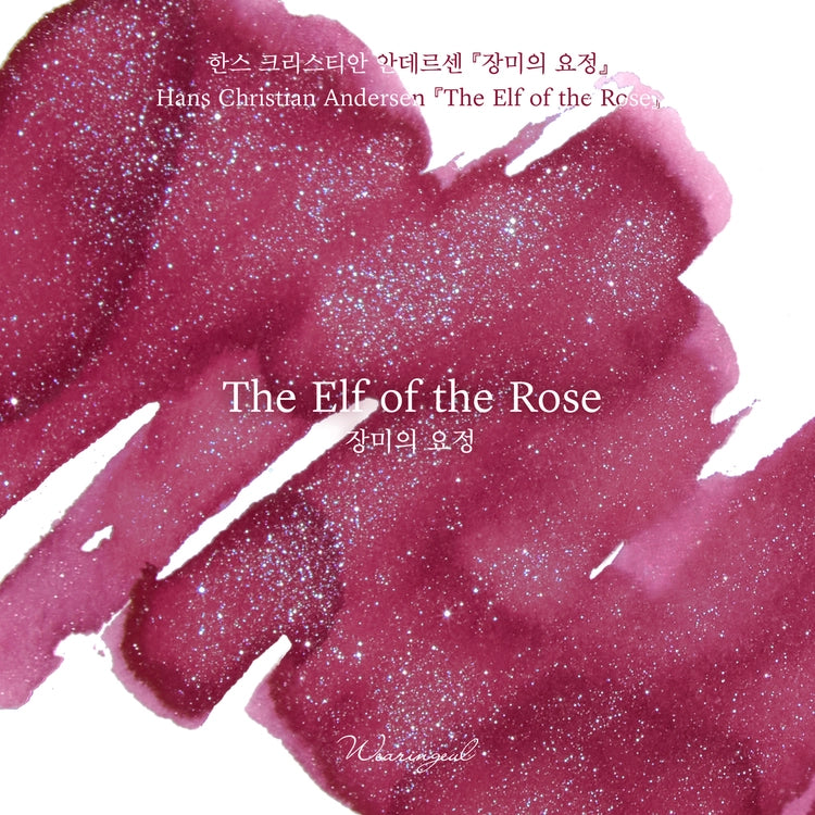 A warm raspberry rose base is accented with cool silver and blue glitter that softly sparkles through the surface, capturing both the beauty and tragedy of human love as seen through the eyes of a fairy.