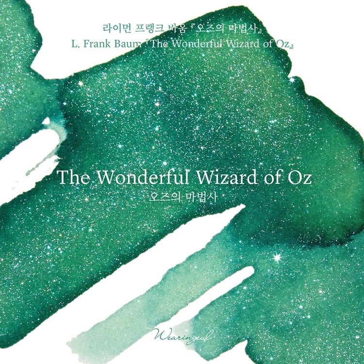 A vivid emerald green is infused with mysterious silver and blue shimmer, weaving through the surface with an ethereal glow and capturing the fantastical journey toward the Emerald City.