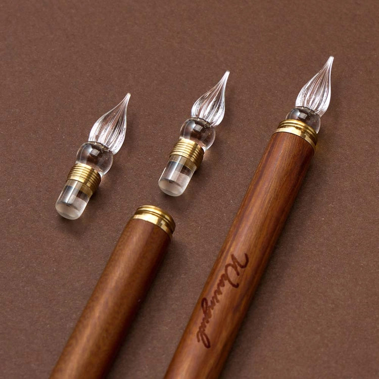 A modular glass pen that combines a glass nib with an elegant rosewood body.
The modular design allows the pen to be used for many years to come due to its easy nib replacement system. Designed to be easy to use and clean, the nib can be detached easily and lightly rinsed with water for cleaning.
The screw on brass cap allows for safe transport and storage making it perfect for use on the go. 