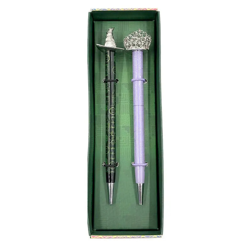 Celebrate your love of Wicked with this set of two ballpoint pens, perfect to use for writing notes, spells, or letters home from your time at Shiz University.
DETAILED DESIGN: This deluxe set contains two ballpoint pens with designs inspired by both Elphaba and Glinda. Each pen features a detailed silver, die-cast metal topper of Elphaba hat and Glinda’s crown.
PERFECT FOR FANS: This pen set makes a wonderful gift and is a perfect way to show your love for Wicked and the beloved characters of Elpha