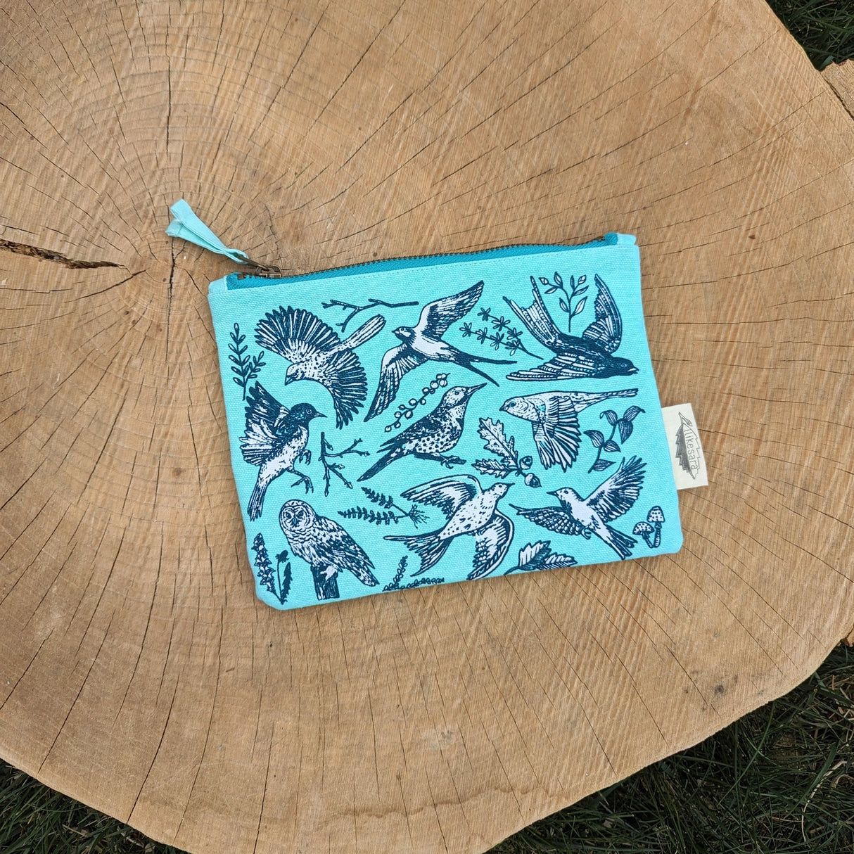 Take some feathered friends everywhere you go with this canvas bird zippered pouch. Featuring bird illustrations by ilikesara (aka Sara Schalliol-Hodge) combined with botanicals, this handy zippered pouch will keep you organized (in flight or on land!). Great for storing snacks, pencils, bird seed, your feather collection, etc. The water-resistant inner layer is not only wipeable but adds structure to the bag.