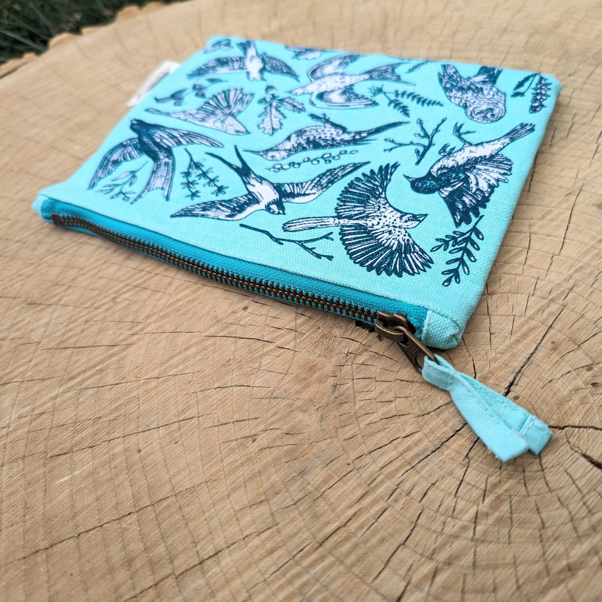 Take some feathered friends everywhere you go with this canvas bird zippered pouch. Featuring bird illustrations by ilikesara (aka Sara Schalliol-Hodge) combined with botanicals, this handy zippered pouch will keep you organized (in flight or on land!). Great for storing snacks, pencils, bird seed, your feather collection, etc. The water-resistant inner layer is not only wipeable but adds structure to the bag.