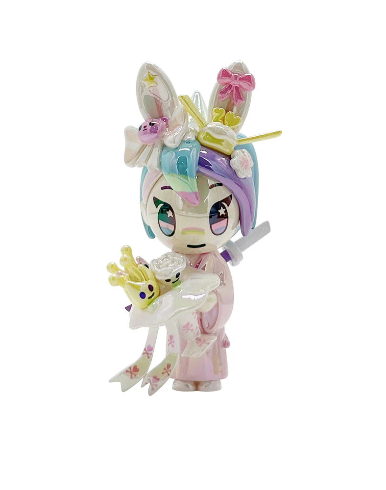 Celebrate 20 years of tokidoki with our 20th Anniversary Blind Box! This series features iconic characters reimagined in party-ready designs, including Donutella, Nijiko, Mozzarella, Adios, Mermicorno, and more—plus a special chaser, Party Bubbly! Join the celebration of two decades of signature & artwork, unforgettable characters, and kawaii culture with this must-have blind box collection for every tokidoki fan!