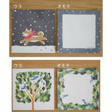 Two sets of illustrated cards with dog and tree designs on a wooden background.