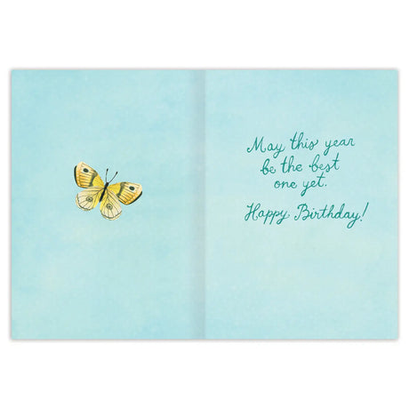 A Year of Wishes Book Stack Birthday Card

Inside verse: May this year be the best one yet. Happy Birthday!

• Gold foil details
• Illustrated by Katie Daisy
• Pre-priced
• Size: A6, 4.5" x 6.25"
• Paired with a Kraft envelope
• Printed in the USA on beautiful FSC-certified 10% post-consumer waste recycled paper.

About The Artist: Katie Daisy was raised by the birds and warm breezes of small-town Lindenwood, Illinois, brought up among the wildflowers with roots planted deeply in the natural world. Working 