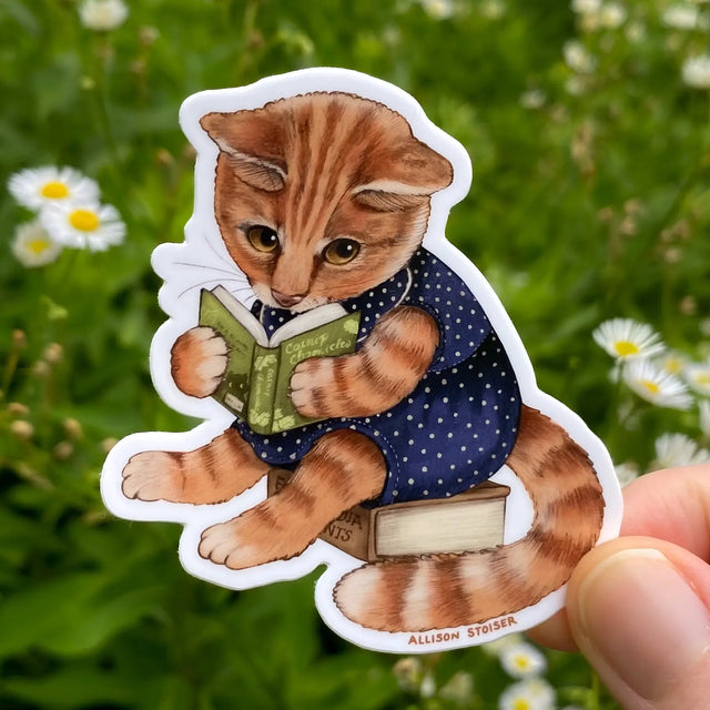 This orange tabby cat is completely immersed in the fantastical world of the Catnip Chronicles!


This 2.5" die-cut gloss vinyl sticker is durable, weatherproof, and perfect for water bottles, notebooks, laptops, bikes, and all sorts of other surfaces! Make sure to clean and dry the surface thoroughly before applying.