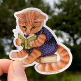 This orange tabby cat is completely immersed in the fantastical world of the Catnip Chronicles!


This 2.5" die-cut gloss vinyl sticker is durable, weatherproof, and perfect for water bottles, notebooks, laptops, bikes, and all sorts of other surfaces! Make sure to clean and dry the surface thoroughly before applying.