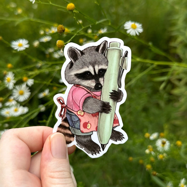 This little raccoon is ready to doodle or write in their planner with their pen!

Original artwork hand-drawn in pencil by Allison Stoiser.