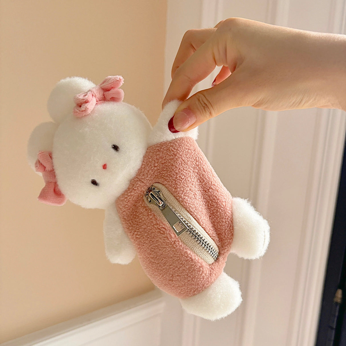 This soft and fuzzy pouch is perfect for carrying small essentials like coins, lip balm, or earbuds. Designed for convenience, it features a sturdy loop so you can easily attach it to your keychain, bag, or keyring.
