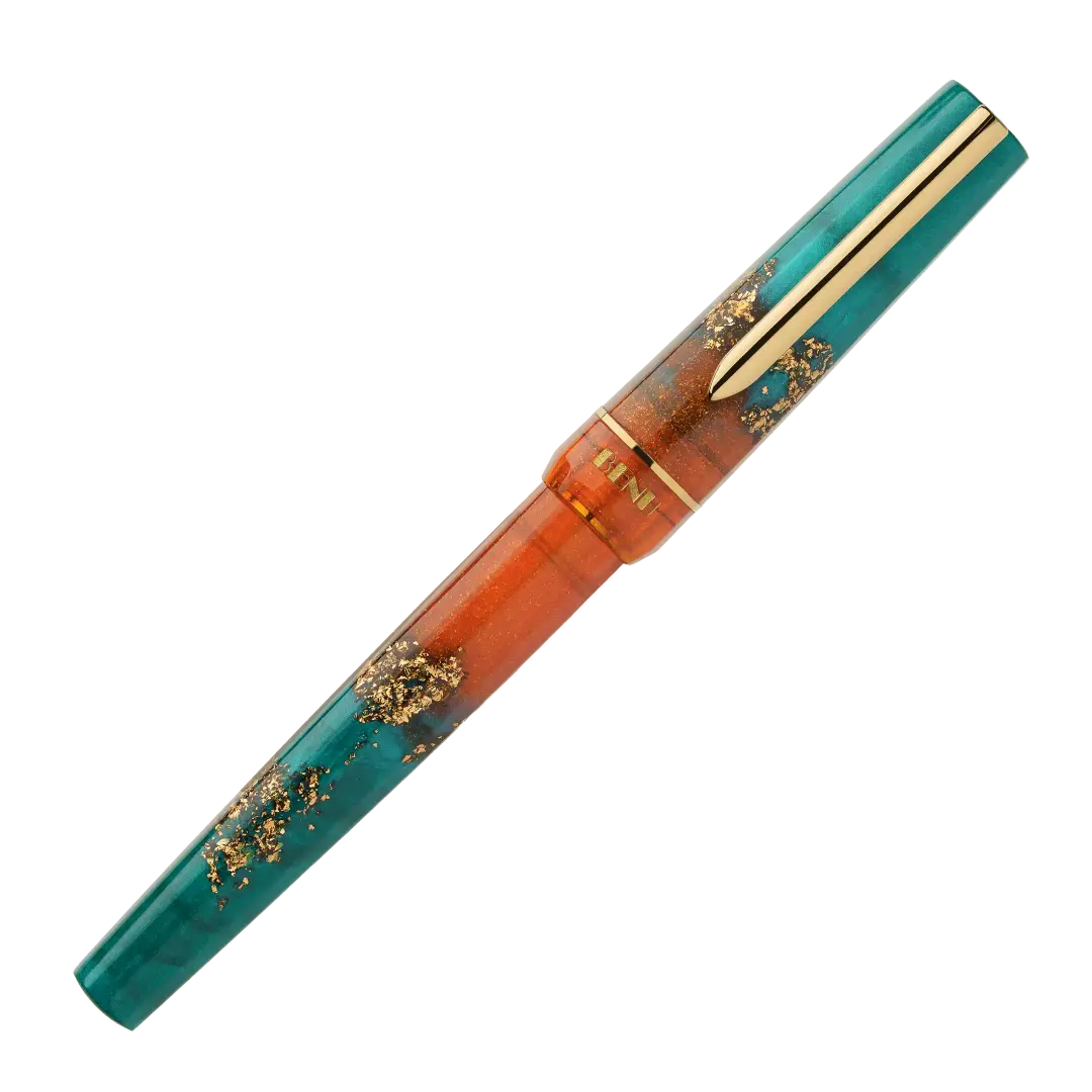 BENU presents the newest Haute Collection — a line of elegant, fashion-inspired pens that blend classic charm with bold, modern flair. The designs include both subtle and vibrant styles, showcasing BENU’s signature glitter and color artistry. Each pen features a faceted body with alternating wide and slender facets, complemented by either gold-plated or chrome-plated trims for a sleek, timeless look.

With a bold orange and teal body streaked with gold, Chic turns heads with runway-ready style. Fashion-forw