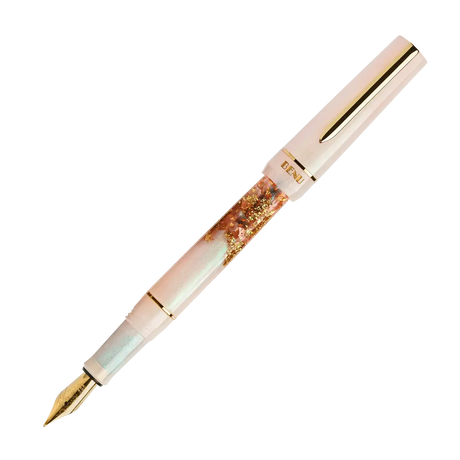 BENU presents the newest Haute Collection — a line of elegant, fashion-inspired pens that blend classic charm with bold, modern flair. The designs include both subtle and vibrant styles, showcasing BENU’s signature glitter and color artistry. Each pen features a faceted body with alternating wide and slender facets, complemented by either gold-plated or chrome-plated trims for a sleek, timeless look.

A mix of golden flakes dances through a soft, pearly pink base, complemented by gleaming gold trim. Tender 