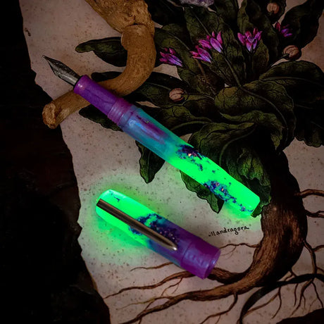 BENU Talisman Fountain Pen - Mandrake

With a long history of use in religious and occult practices, the mandrake plant is particularly noted for its potent roots, which somewhat resemble the human body. There are tales of this plant that date as far back as the bible, in which the scripture links the mandrake with sexuality and fertility. Other legendary stories suggest that the plant has magical, and sometime menacing, powers.&nbsp;

This pen glows beautifully in a dark and semi-dark with a green color af