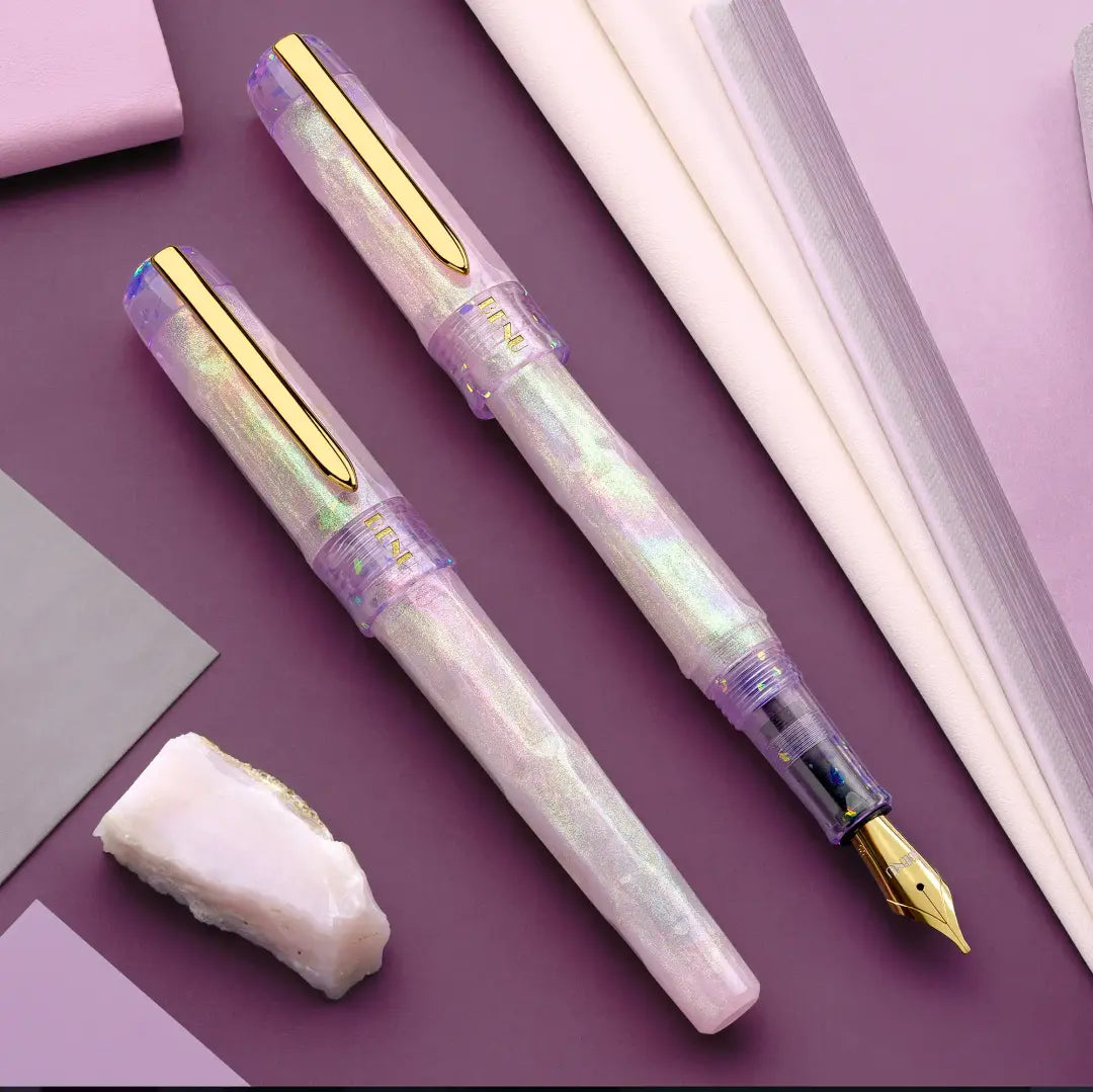 BENU Talisman Fountain Pen - Pink Opal

Inspired by the soft beauty and symbolism of the Pink Opal stone, Pink Opal joins BENU’s Talisman Collection — a series dedicated to legendary substances, natural materials, and symbols believed to carry meaning, protection, or good fortune across cultures and history.


The design captures the delicate character of pink opal through a palette that shifts between gentle cotton pink and soft lavender tones. Pronounced pearlescent effects and light-shifting properties c
