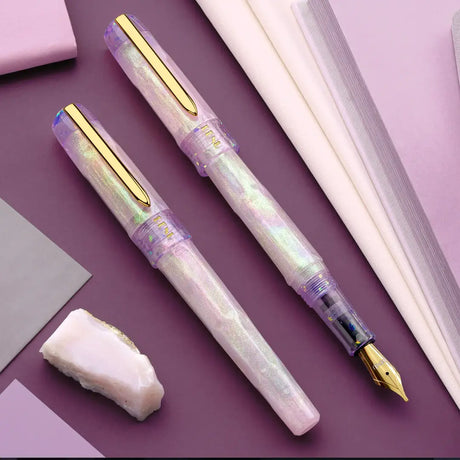 BENU Talisman Fountain Pen - Pink Opal

Inspired by the soft beauty and symbolism of the Pink Opal stone, Pink Opal joins BENU’s Talisman Collection — a series dedicated to legendary substances, natural materials, and symbols believed to carry meaning, protection, or good fortune across cultures and history.


The design captures the delicate character of pink opal through a palette that shifts between gentle cotton pink and soft lavender tones. Pronounced pearlescent effects and light-shifting properties c