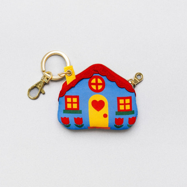 For homebodies on the go! Pop this adorable cottage on your favorite going-out bag for some lace-trimmed, puppy-loving charm. It’s perfect for stashing earbuds or small knick knacks – or just for a sweet reminder that your heart’s always home.