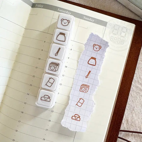 This button stamp captures Bear's favorite things!!

Fountain pens, inks, happy mail, planners, and clips!!

Our stamps add a sweet and cute touch to your planner or journal. Add them in your journaling, planning, and memory keeping spreads!

Stamped image is approximately 0.8cm wide.