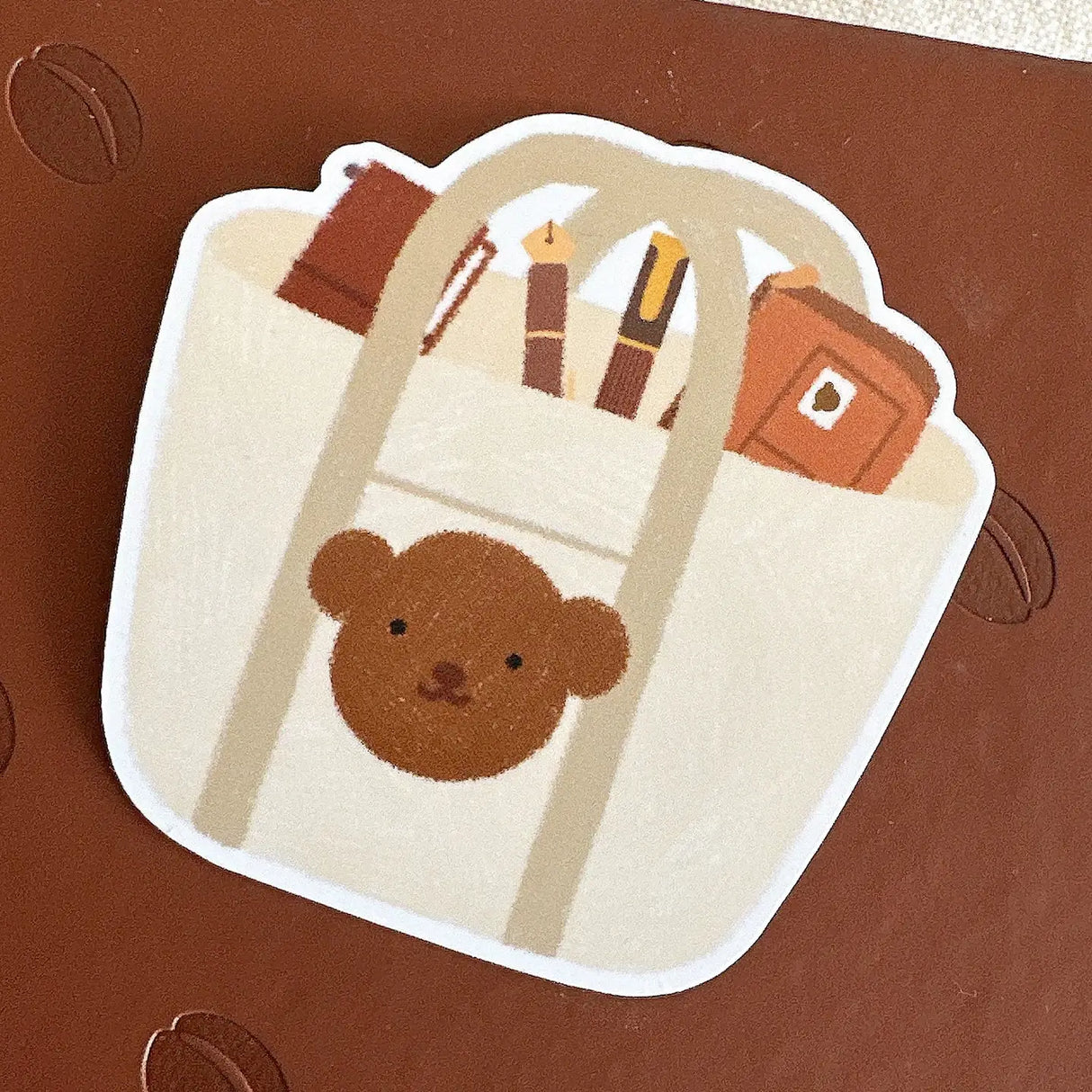 Bloom Paper Studio Die Cut Sticker - Choco's Planner Bag

Choco's tote bag contains his planner pouch, fountain pens, and traveler's notebook!

made with:
- premium matte sticker paper
- weatherproof
- 2.4"x2.4"

Note: Colors on screen may appear slightly different on paper. By purchasing, you have acknowledged reading this disclaimer.