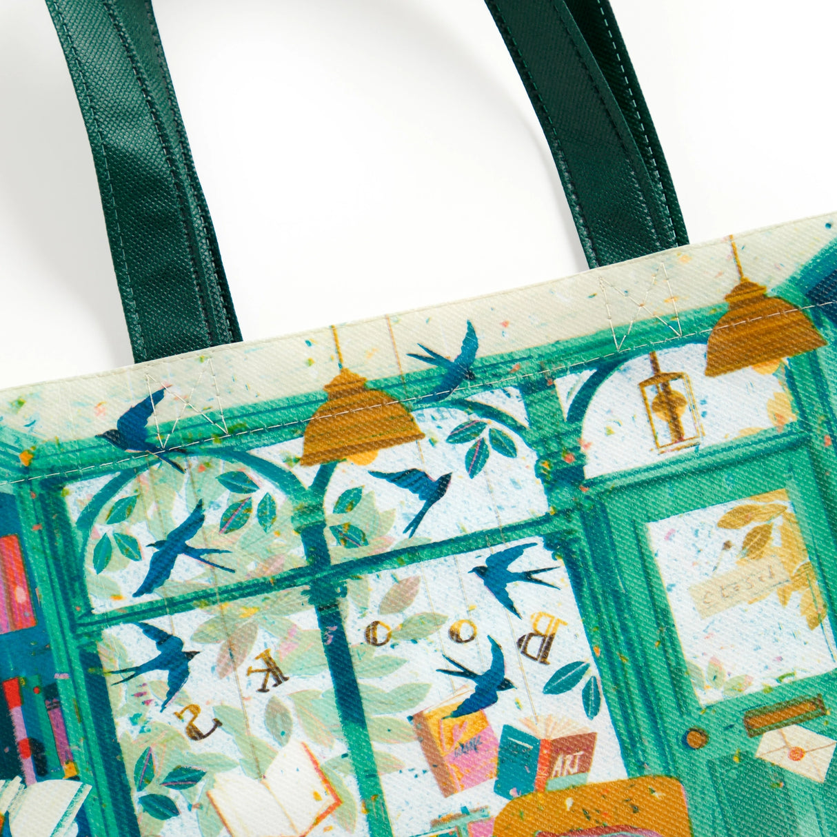 Carry your groceries and essentials in eco-friendly style with the Bookshop Afternoon Reusable Shopping Bag (artwork by Victoria Ball). Lightweight and durable, this bag is crafted from eco-friendly materials, making it the perfect sustainable choice for your shopping trips and travels. Featuring charming artwork inspired by books, it adds a touch of whimsy to your errands. With ample space and sturdy handles, it's perfect for carrying groceries, books, or travel essentials. 