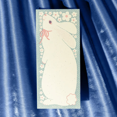 The sweetest little bunny is ready to hold your sweetest notes. Ditsy polka dots and a spray of little white flowers frame the white rabbit. Risograph printed in federal blue and light mauve.