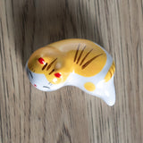 Porcelain yellow cat chopstick rest / pen rest.