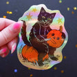 Cat Coven - Pumpkin Carver Holographic Vinyl Sticker

Celebrate your love for Halloween with this cute new pumpkin carver vinyl sticker! This sticker is perfect for your journal, water bottle, laptop, and more.

Waterproof, UV protected &amp; high temperature resistant
3 x 4 inches and holographic!
Colors may vary slightly from your computer screen to real life product