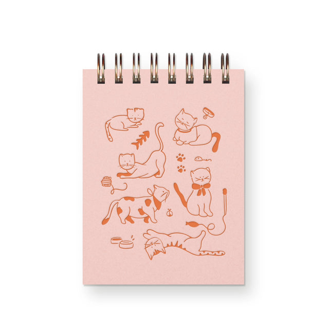 For the feline lover who knows cats rule because they're independent, chill, and furry soft. These playful purr balls are not only adorable but they want you to scribble down the name of that new treat or ideas for world domination, all inside the pages of this mini notebook.

Additional Details :

3”x4"
65 Unlined Interior Pages
Uncoated Vellum 70# Text Off-White Interior Paper
Bronze Wire-O Binding
Locally Made in Lawrence, Kansas