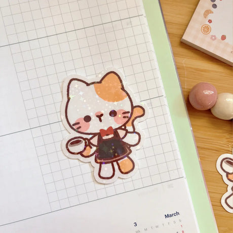 Decorate your laptop, notebook, planner, phone case, or just about anything that might need a little extra fun with this adorable Cafe Cat die-cut sticker.

Size: 50mm x 60mm

Material: Flitter Laminate&nbsp;

Waterproof

Includes 1 sticker